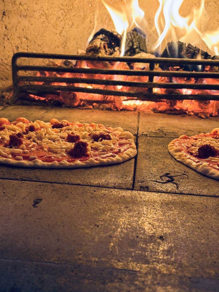 Wood-fired pizzas cooking during wedding catering at Fallow Forest in Cannock